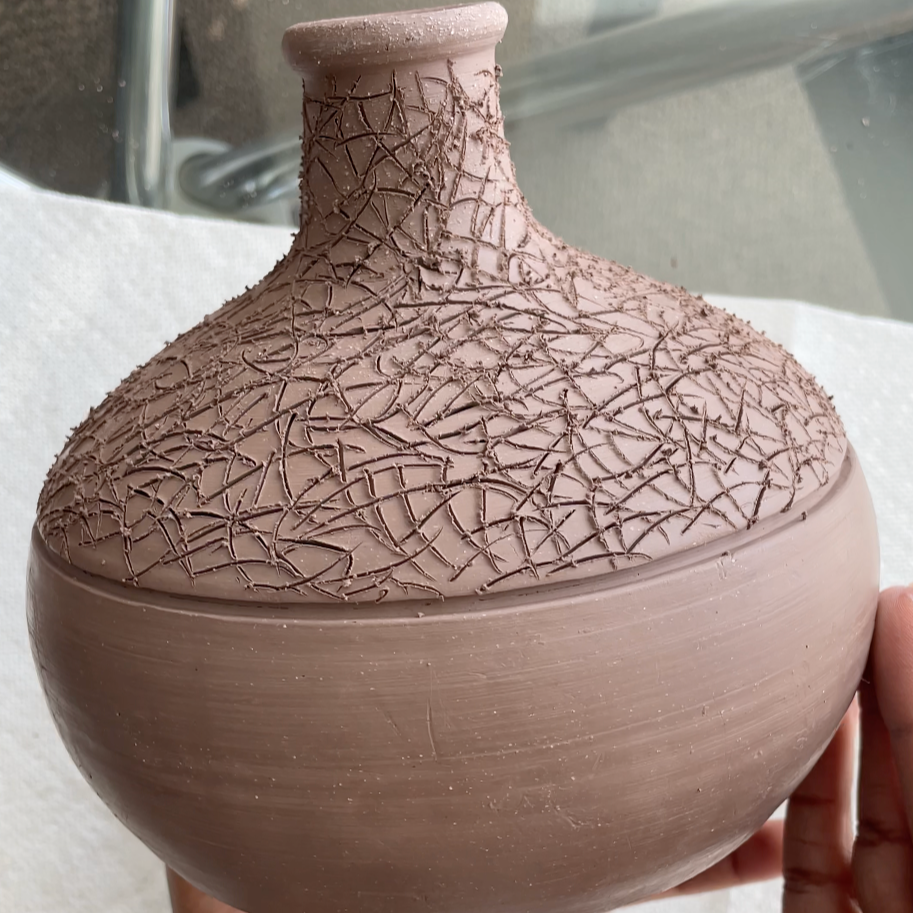 A leather hard, unfired, stonewear  ceramic vessel